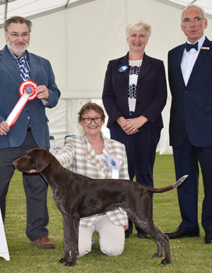 Mr & Mrs P Rose Kavacanne at Karwendel with puppy group judge Mr P Wilkinson & Mr W Browne-Cole (Chairman) 