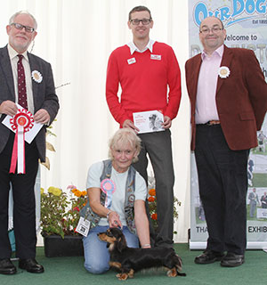 Mrs C Dare Larkhund Sofia with puppy group judge Mr S Parsons & Mr J Wolstenholme (Royal Canin)