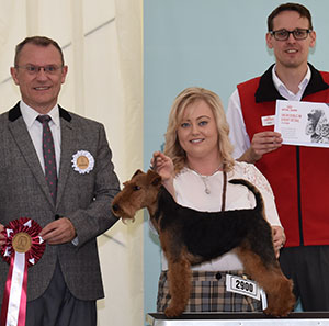 Mr & Mrs D J & W A E Hughes & Miss R Pearce Knowlelion Sassy Boots with puppy group judge Mr F Whyte & Mr J Wolstenholme (Royal Canin)