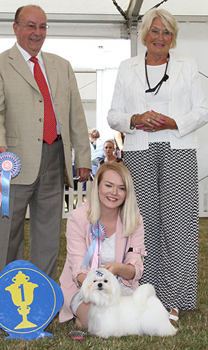 Miss C Balfour Suncube She Has It with puppy group judge Mr K Nathan & Mrs E Stannard (Secretary) 