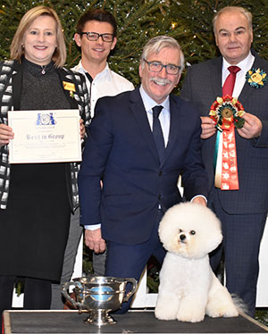 Messrs M Coad & R Smith Ch Regina Bichon You Rock My World at Pamplona with group judge Mr G W Farmer