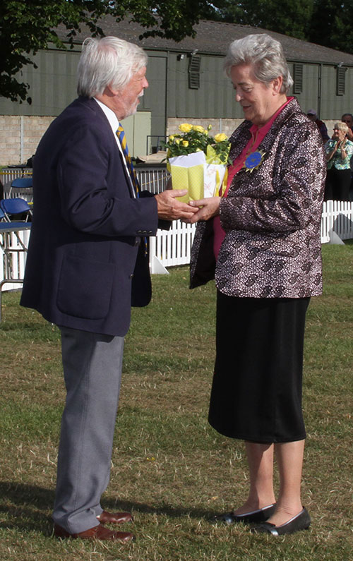 Chairman Mr M Taylor presenting BIS judge Mrs C E Cartledge with some flowers celebrating their Golden Anniversary show 